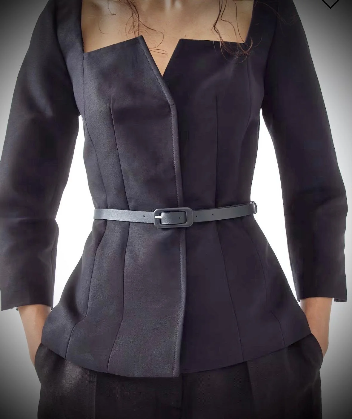 The square neckline with a subtle V-shaped opening adds a touch of allure, while clean lines and tailored seams create a polished, sculpted finish. Finished with 3/4 sleeves and delicate slit cuffs, it’s a piece that feels both powerful and distinctl