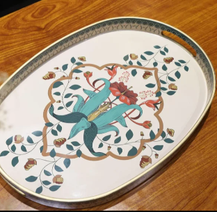 A decorative tray with a bit of shape and detail of its own, doing double duty as both a functional catchall and a design piece. In an eclectic space, a tray like this becomes the anchor that pulls smaller collected pieces, vases, candles, trinkets, 
