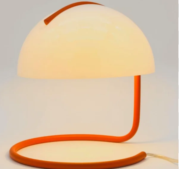 Standing 10.5" tall with a dinner-plate base, this retro mushroom lamp fits nightstands, desks, and small side tables without crowding them. A clean silhouette pulling from Bauhaus, Scandinavian, Danish, and mid century modern design. The orange base