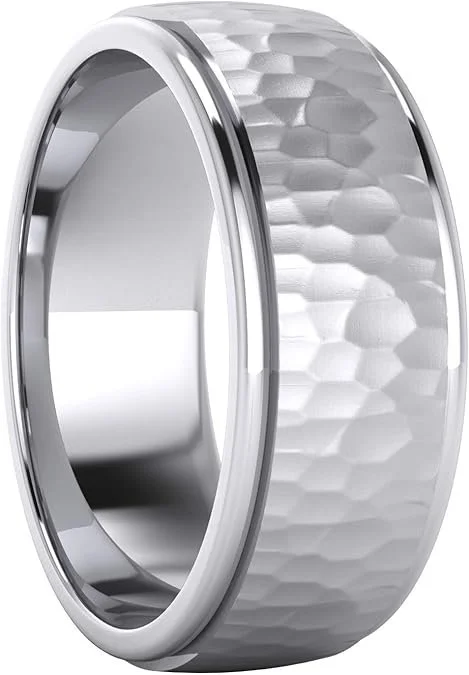 A  silver comfort fit ring which brings a solid expression of craft and permanence. Forged in sterling silver, this band combines a hammered center with polished sides, creating a subtle contrast between texture and refinement. 