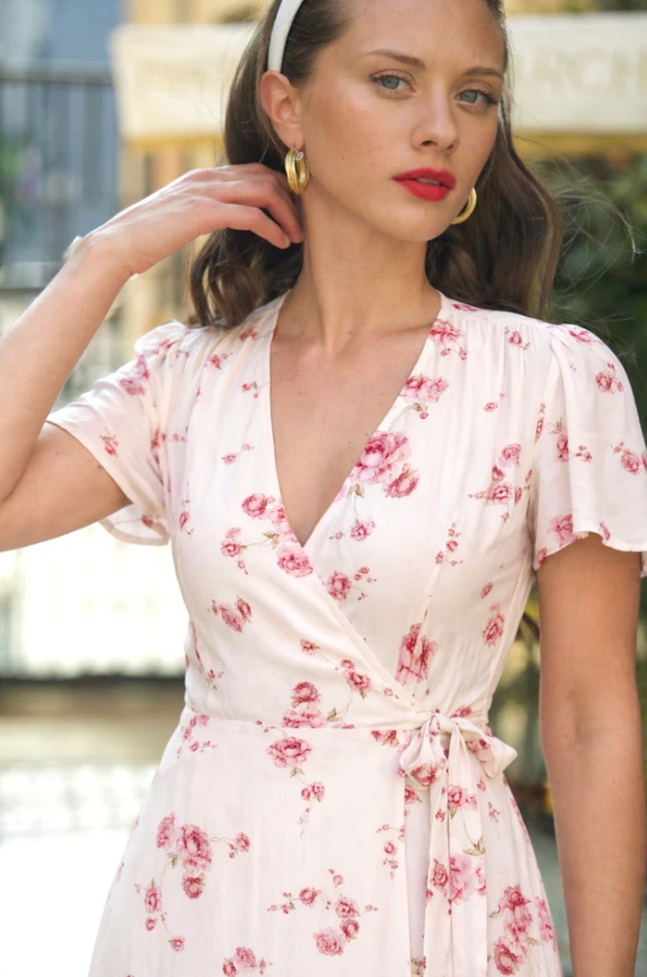 Crafted from a premium upcycled viscose-rayon blend with a viscose lining, this midi wrap dress features a peony print created by our in-house artisan. It is detailed with petal sleeves, a plunging V-neckline, and a waist-cinching tie that opens to a
