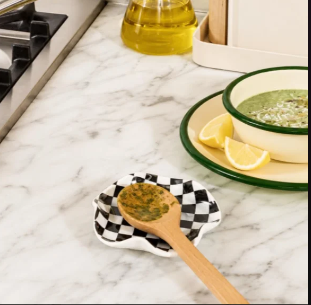 A small ceramic spoon rest in a graphic checkered pattern, practical enough for daily cooking and charming enough to leave out. A little detail that adds character without asking for attention.