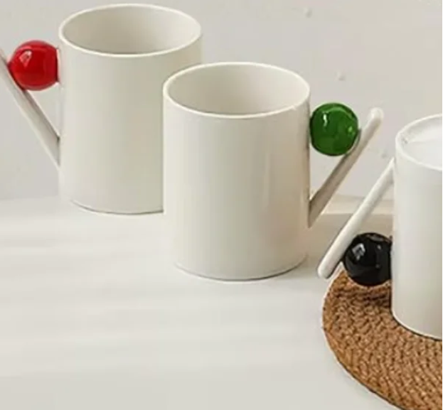 Mazeology Bauhaus Porcelain Coffee Mugs with Colorful Ball Handles.

Add a playful pop of color to your morning routine with this delightful set of four Bauhaus-inspired porcelain mugs. Each pristine ivory mug features a unique, modern handle design 