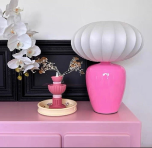 Vintage inspired table and bedside lamp featuring a rich, dopamine hued base paired with a soft silk lampshade. Its ambient glow and playful colour palette add a cheerful, eclectic touch to any bedside or tabletop styling.