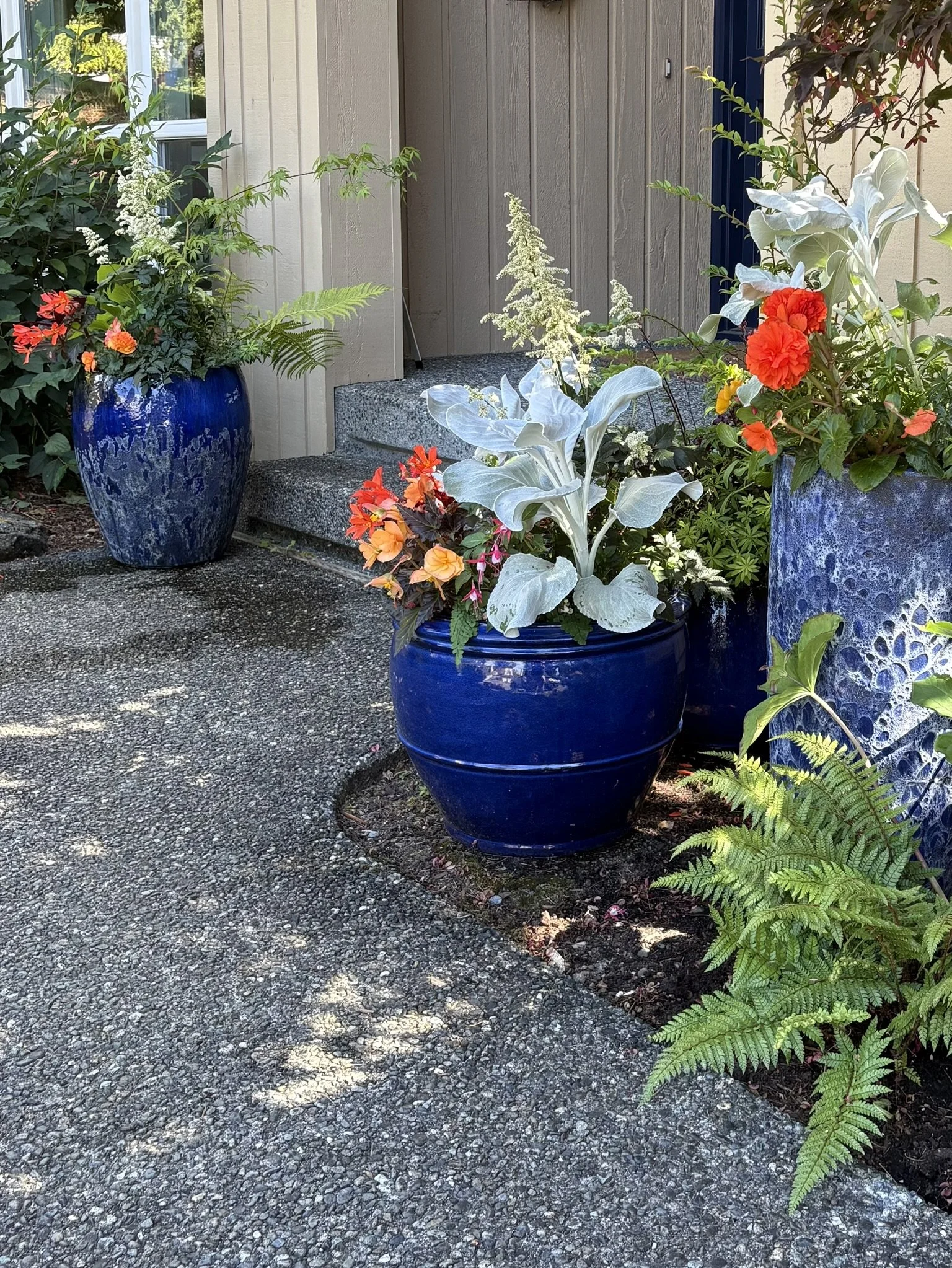 Close-up of a custom porch planting with mixed seasonal blooms