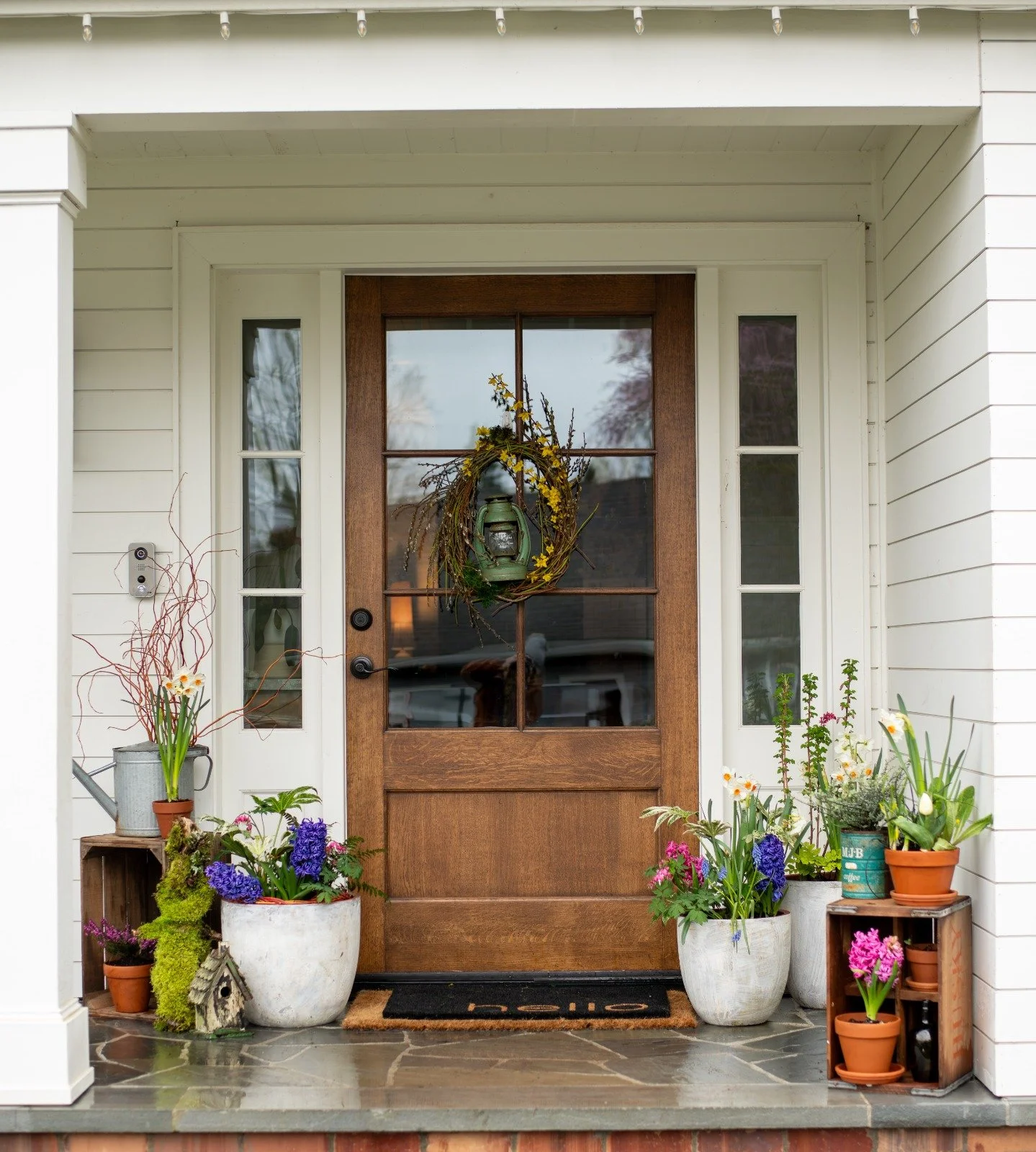 Custom porch design with seasonal planters at the front entry