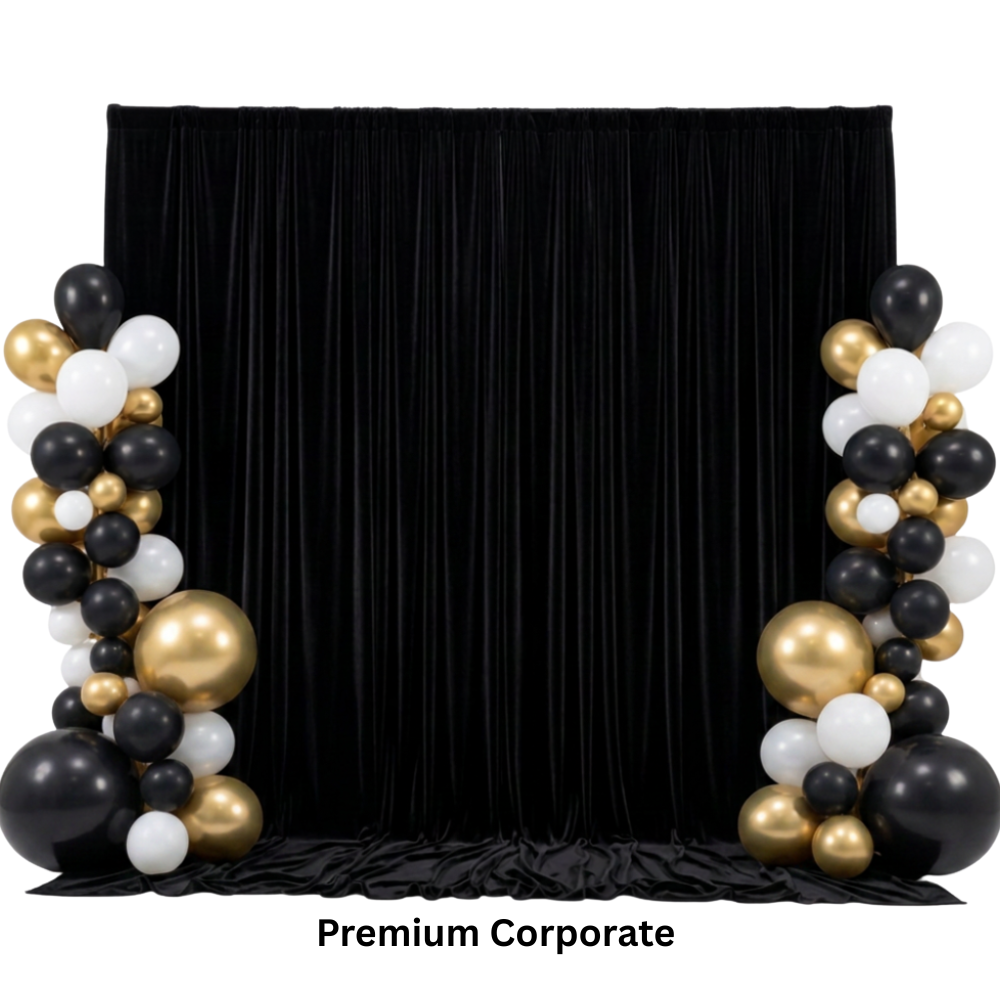 Black backdrop with black, white, and gold balloons arranged on either side for a corporate event using a photo booth