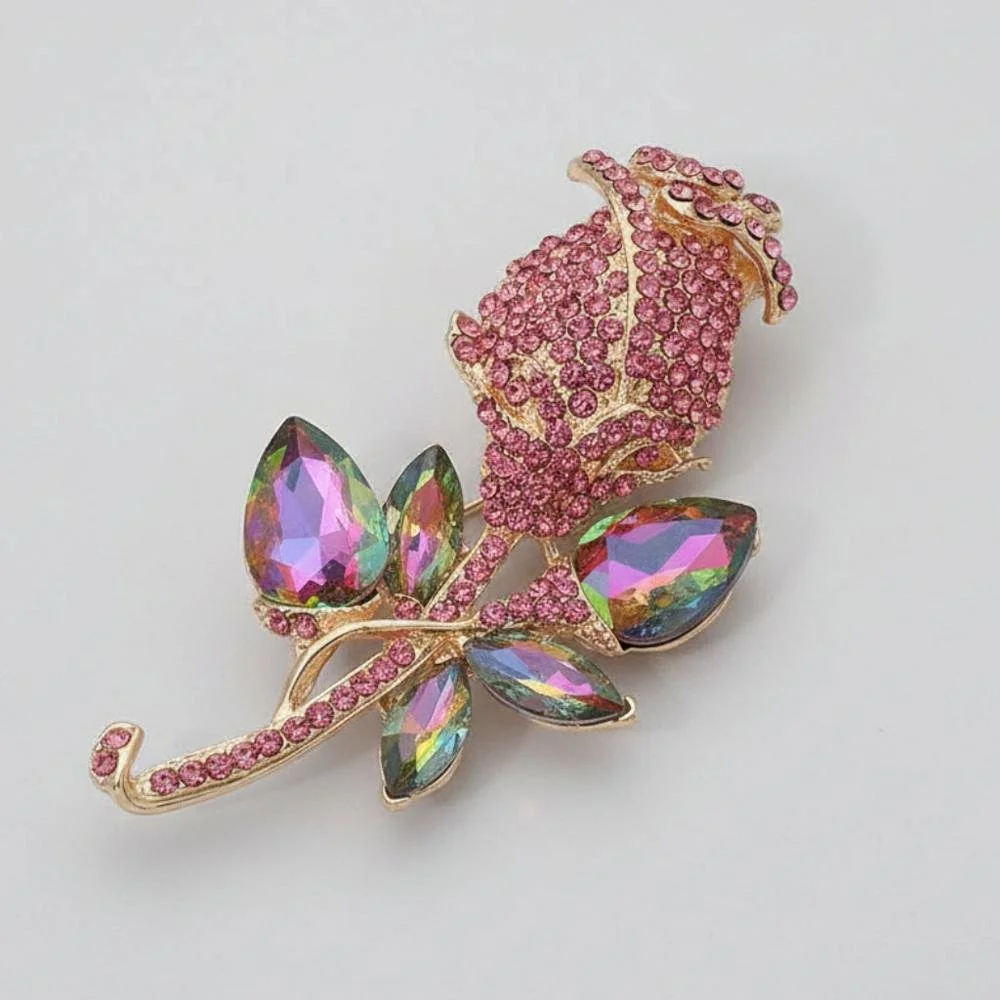 Pink vitrail glass rose brooch on a gray background