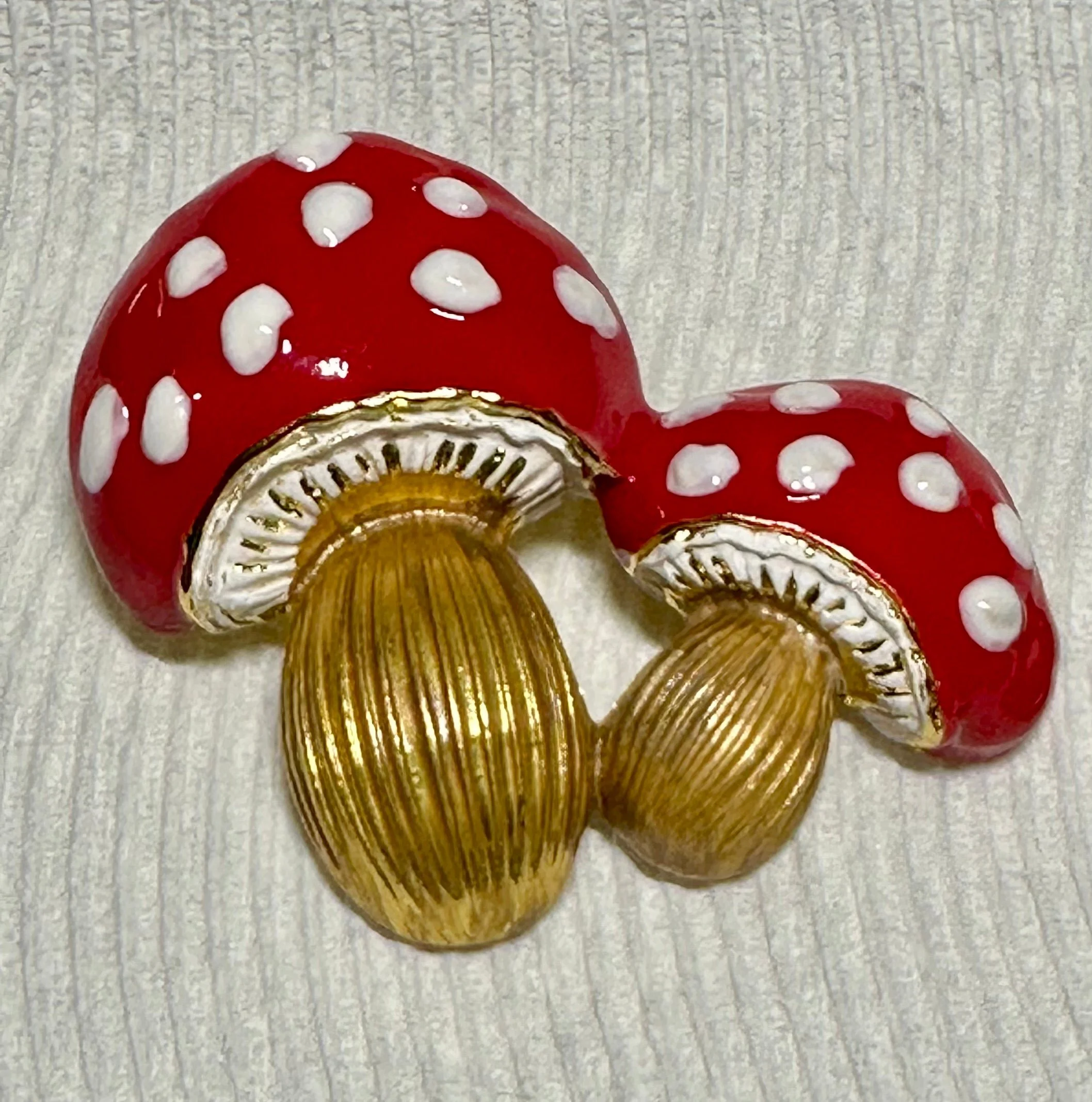 Double mushroom brooch displayed on a white background
