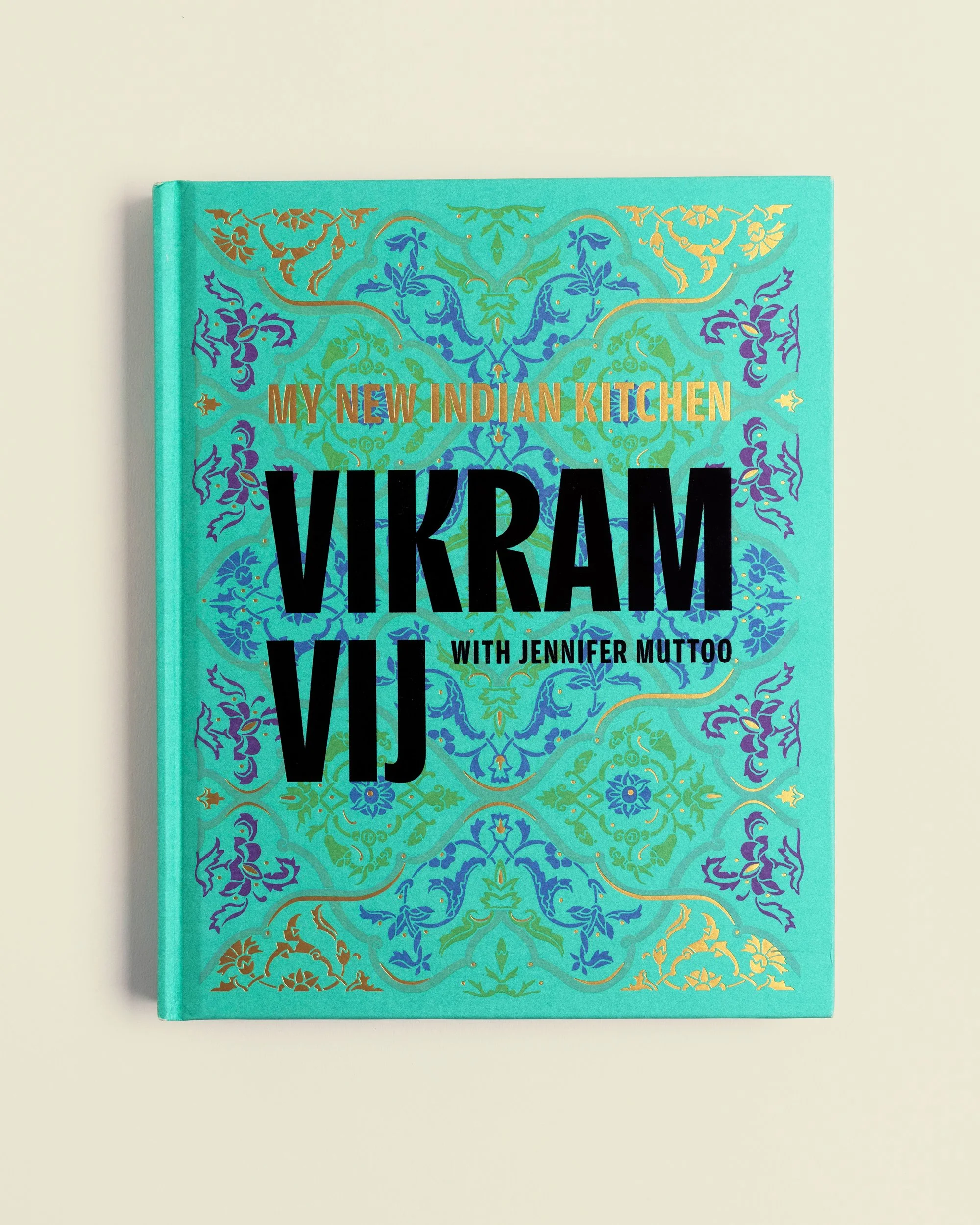 My New Indian Kitchen cookbook cover design by DSGN Dept. for chef Vikram Vij with Jennifer Muttoo, teal cover with gold and purple ornamental pattern