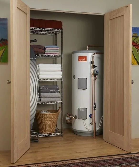 Closet with water heater, metal shelving with folded towels and a laundry basket.