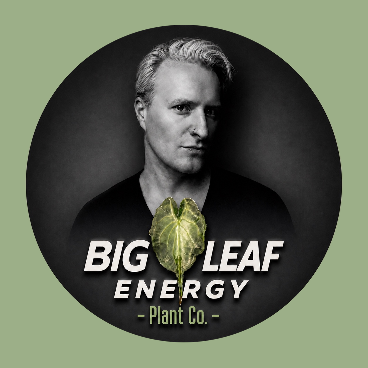Black and white portrait of a person with short, light-colored hair, a nose piercing, wearing a dark shirt, with a green leaf-shaped energy logo in front of them, and text that reads "Big Leaf Energy - Plant Co."