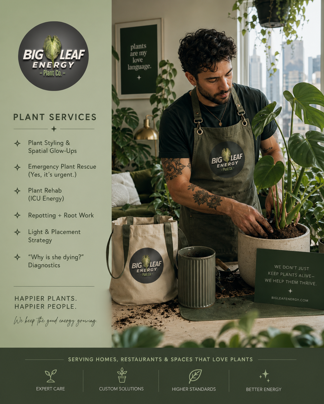 A man with curly dark hair and tattoos, wearing a Big Leaf Energy apron, is repotting a large green plant with broad leaves in a white pot, inside a well-lit room with large windows and other plants.