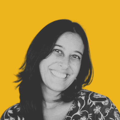 Portrait of a smiling person with long, dark hair.