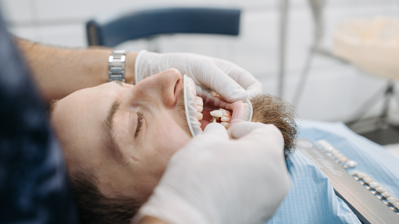 Dentist examining a patient's teeth in a dental clinic.