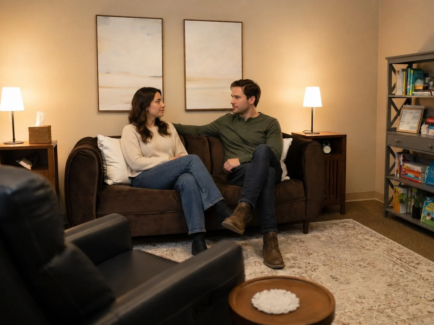 Couple talking together on a couch during a couples therapy session