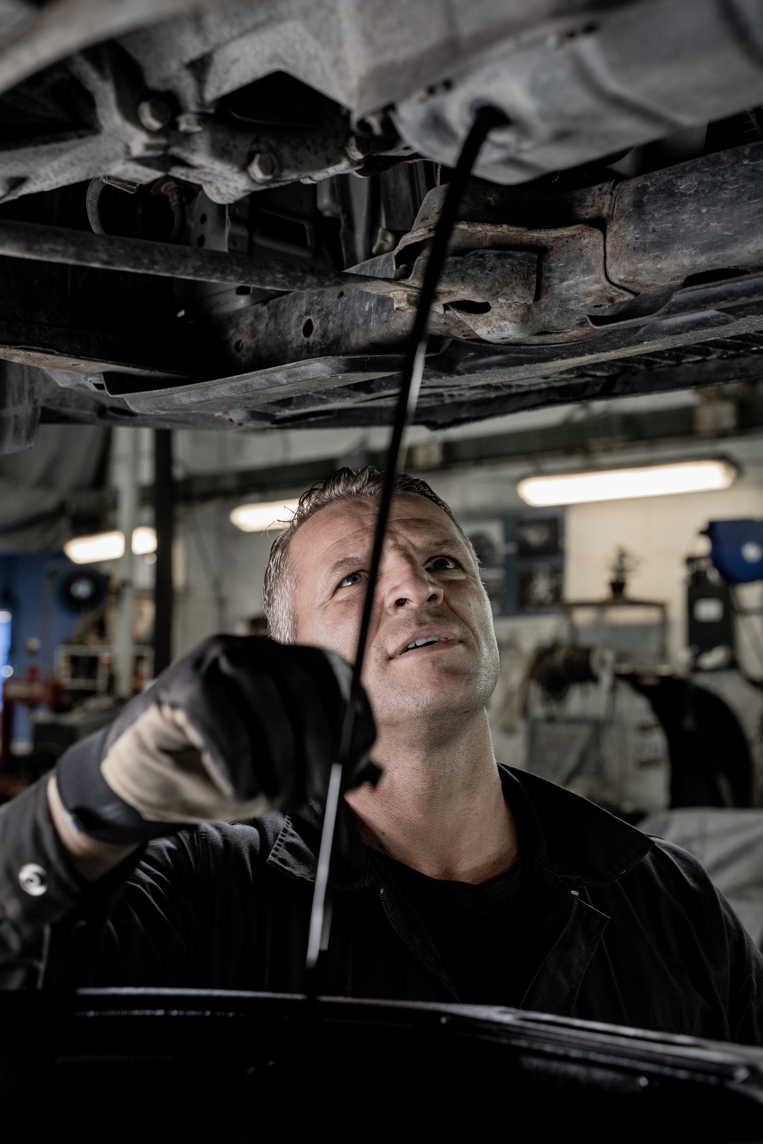 Mechanic inspecting car