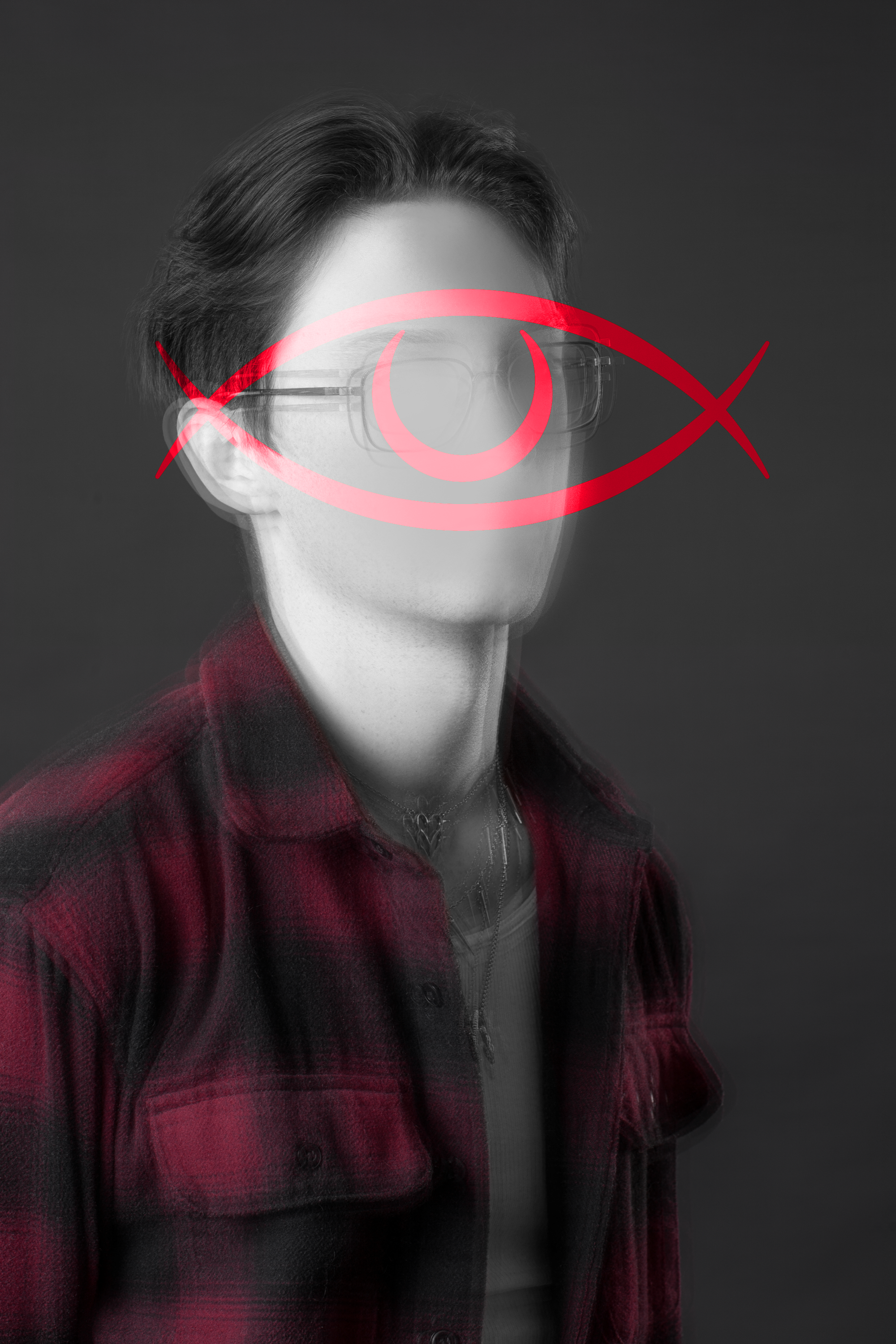 Black and white portrait of a person wearing glasses and a red plaid jacket, with a red eye graphic overlay on their face.