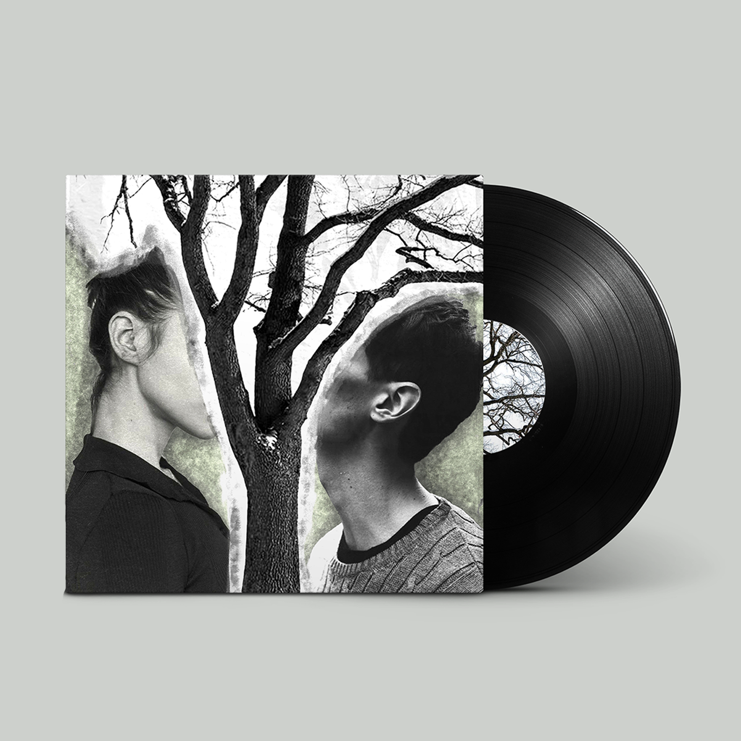 Vinyl record cover with black-and-white photo of a man and woman facing each other with a tree and branches between them.