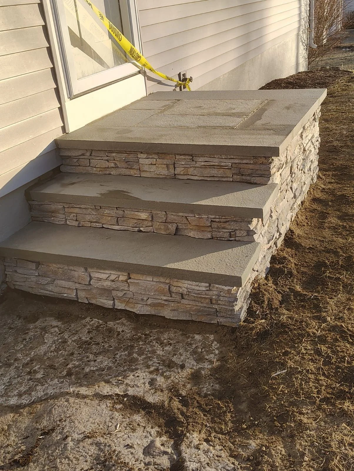 This project involved a front stoop installation with stone veneer finish, designed to improve curb appeal and provide a clean, durable entryway.