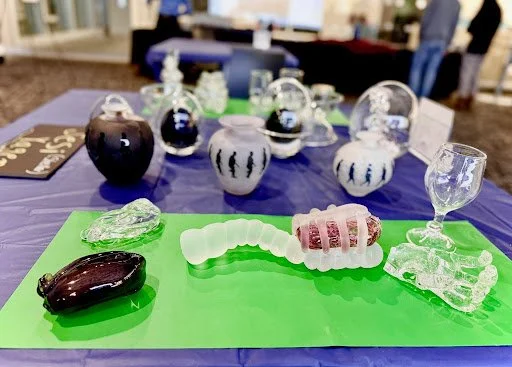 various glass artifacts presented at a convention.