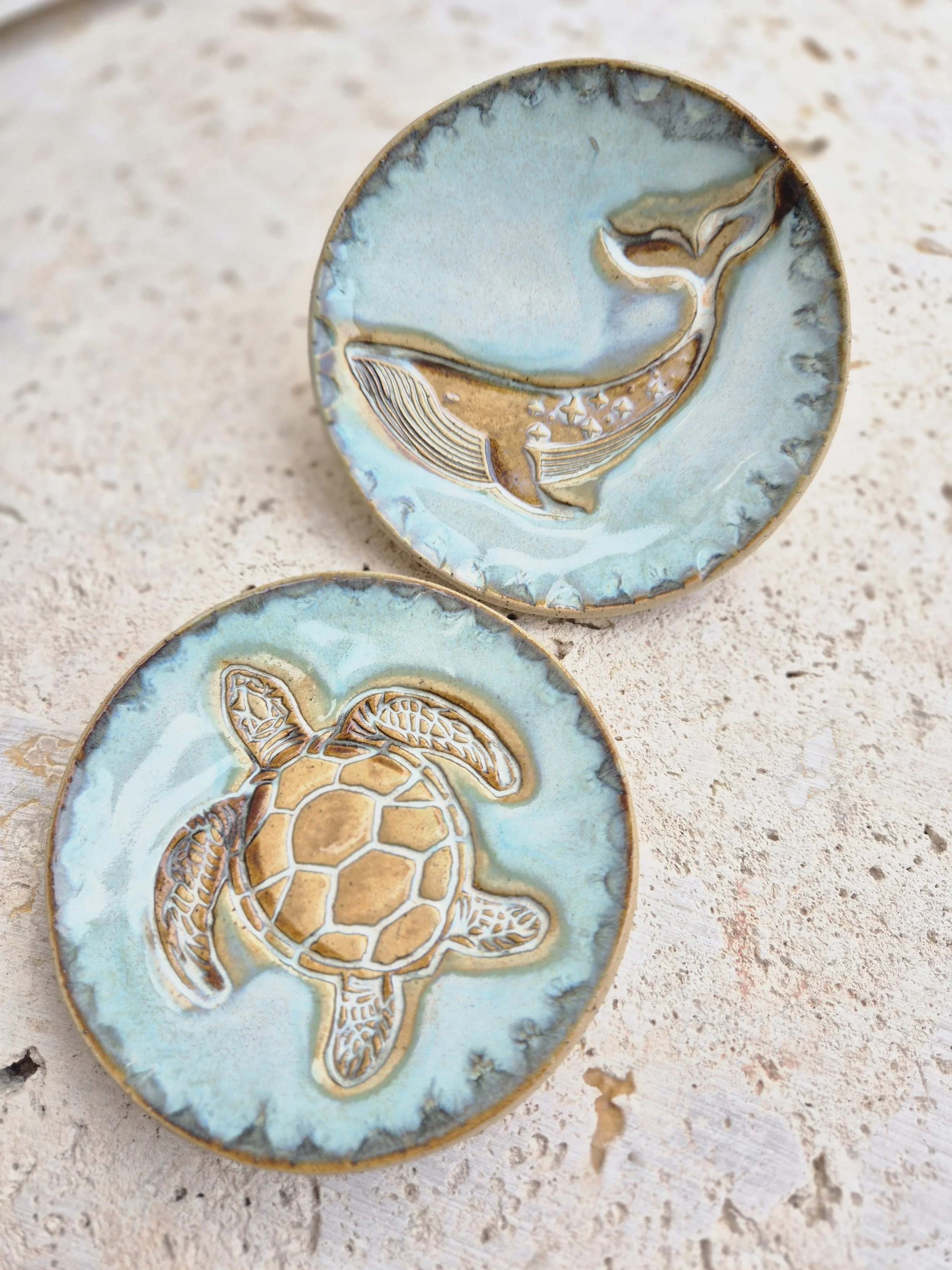 Handcrafted ceramic dish featuring delicate sea creature motifs.