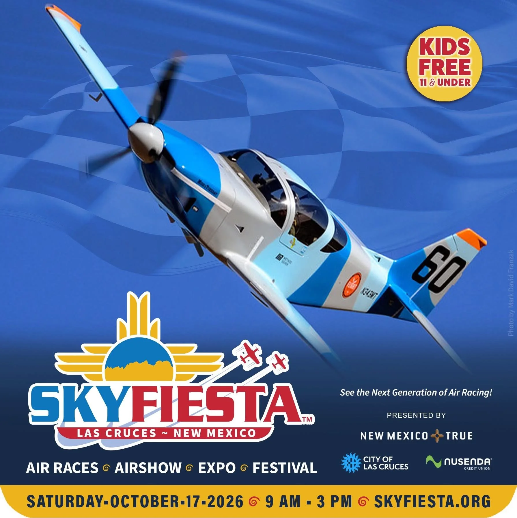 A promotional poster for Sky Fiesta 2026 featuring a cockpit view of an aerobatic airplane in flight against a blue sky. The event is scheduled for October 17, 2026, from 9 AM to 3 PM in Las Cruces, New Mexico, and offers air races, airshow, expo, and festival activities. The poster highlights that kids under 11 are free.