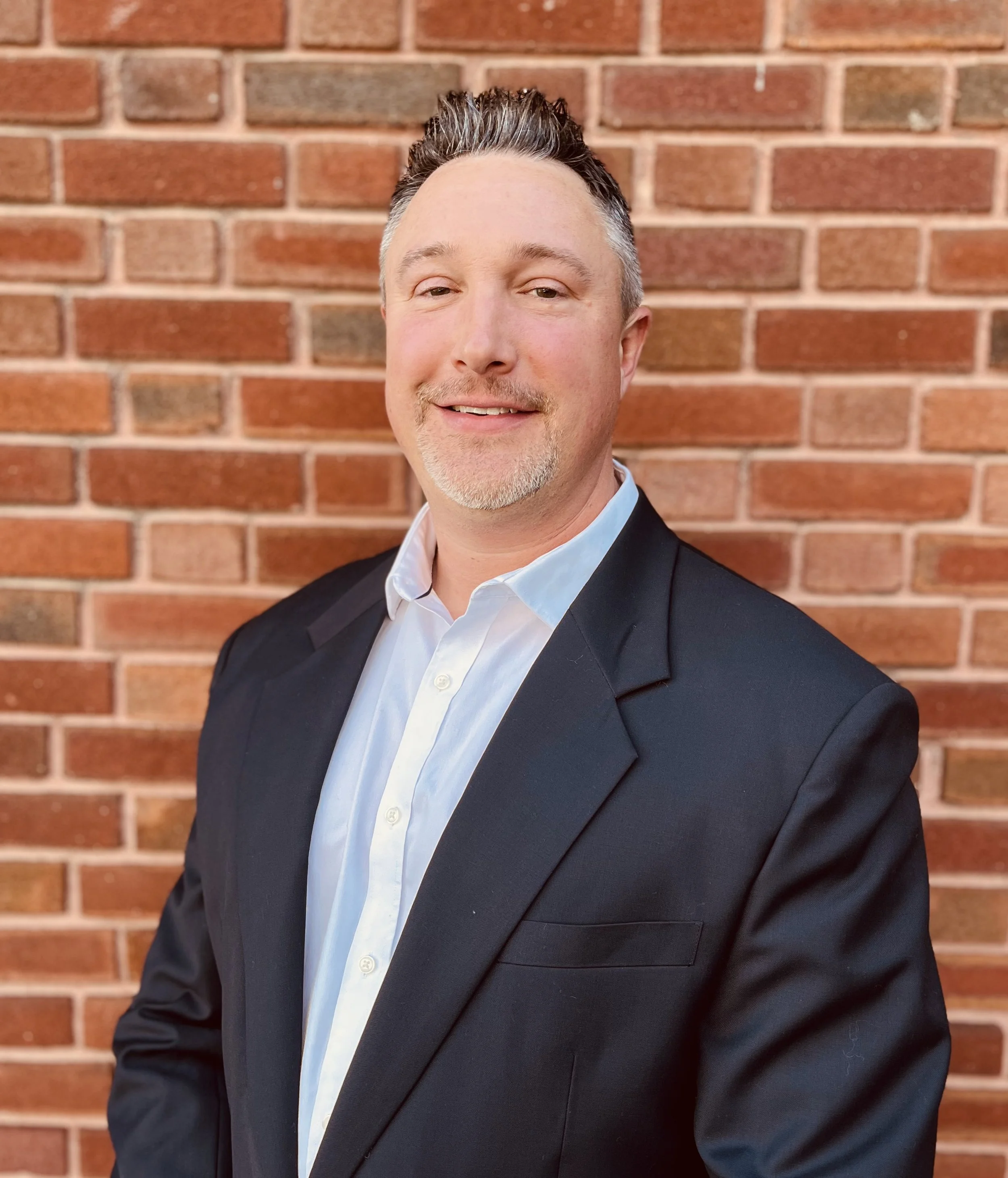 A man in a dark suit jacket Dr. Blake Staker metabolic specialist, director of Lancaster Metabolic Health.