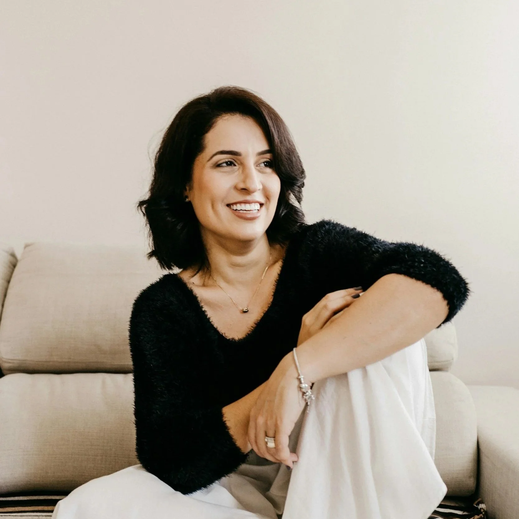 A woman smiling since she is happu with her medical weight loss.