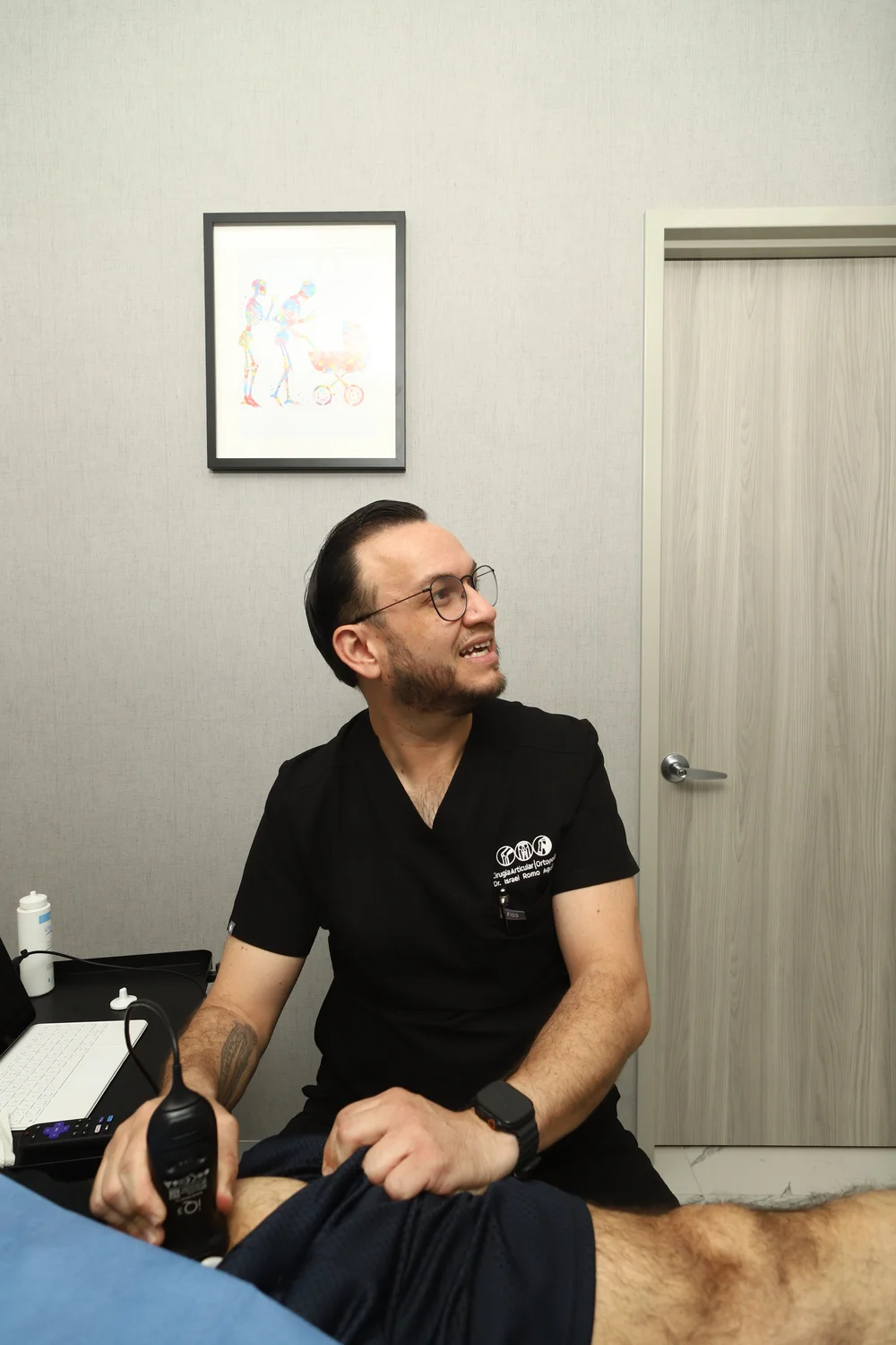 El Dr. Israel Romo, cirujano articular, con el transductor de ultrasonido sobre la cadera en su consultorio en Guadalajara