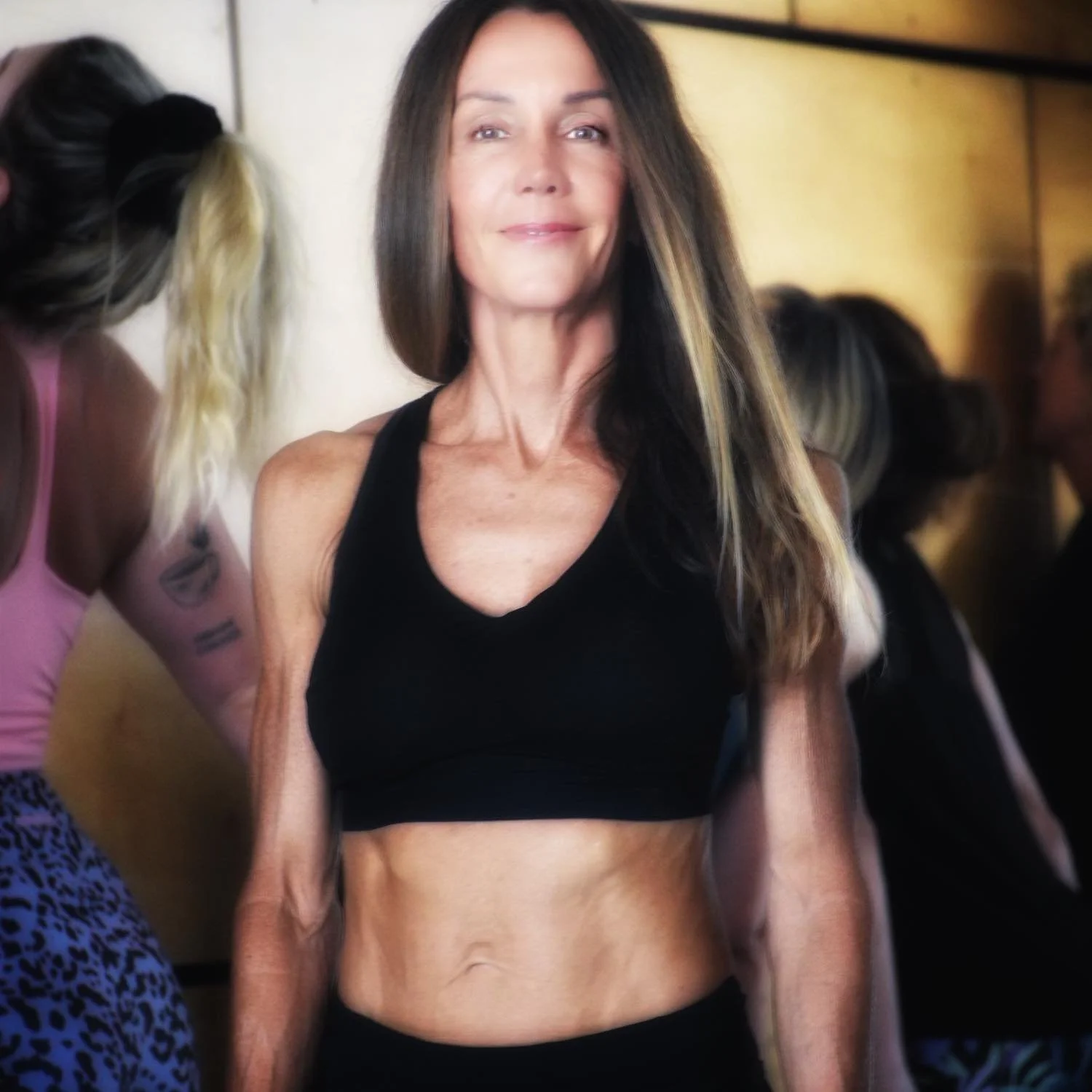Leanna From Expansion Wellness at a gym with a confident smile, ready to help you with your wellness journey
