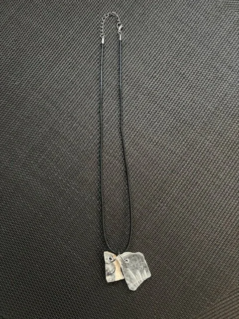 Unique one piece of drilled ceramic and one rare clear glass on a 18 inch leather necklace