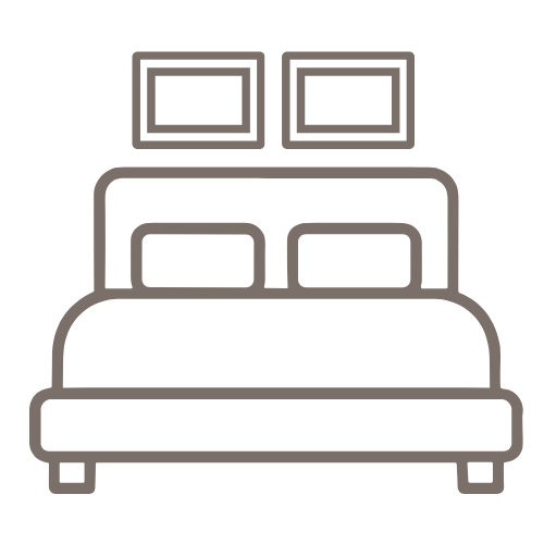 Line drawing of a bed with two pillows and two framed pictures hanging above it.