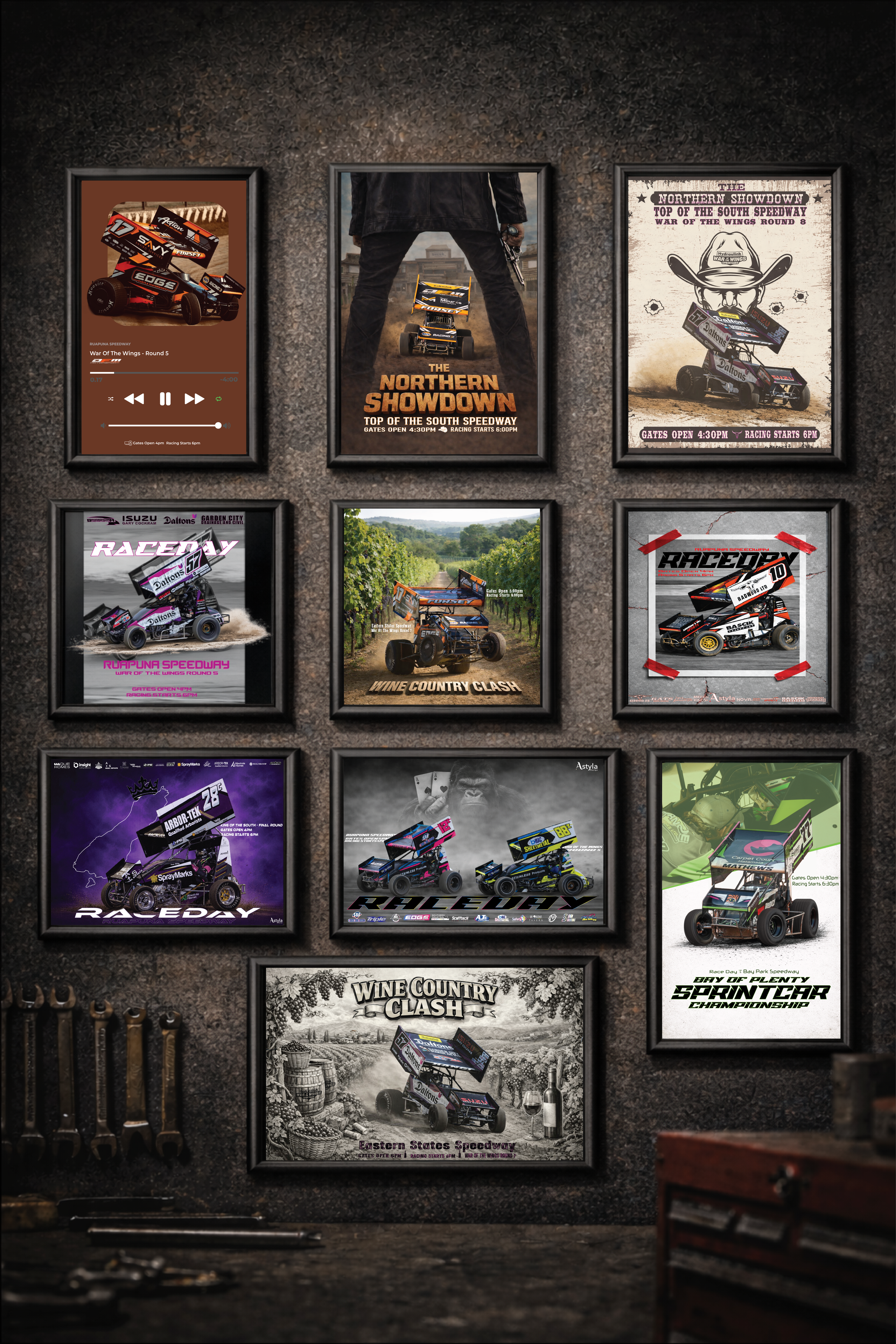 A wall decorated with framed posters and images of motor racing, sprint car events, and speedway races. The posters feature various racing cars, event titles, and promotional images, with some in color and others in black and white.
