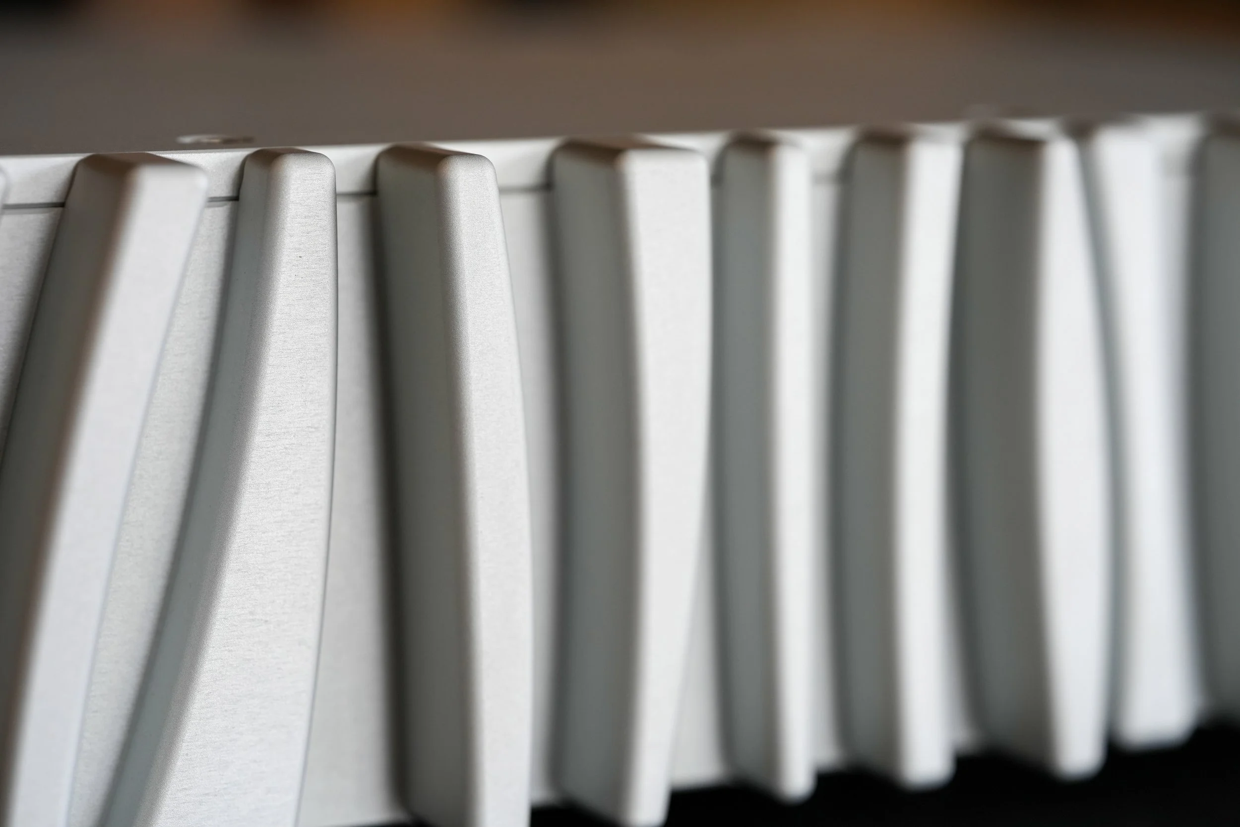 Close-up of a metallic radiator with vertical fins.