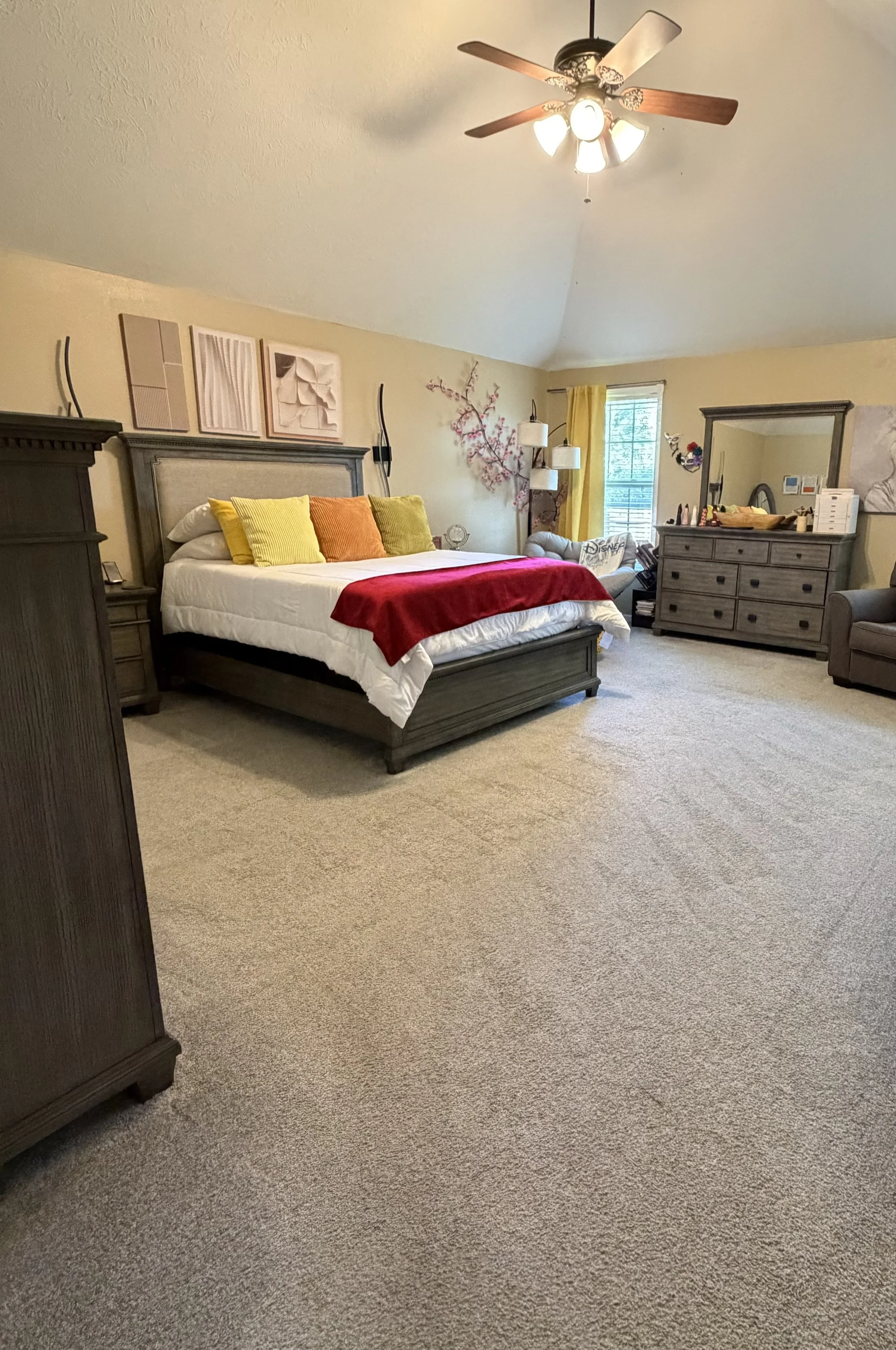 Freshly cleaned bedroom with a neatly made bed and vacuumed carpet.