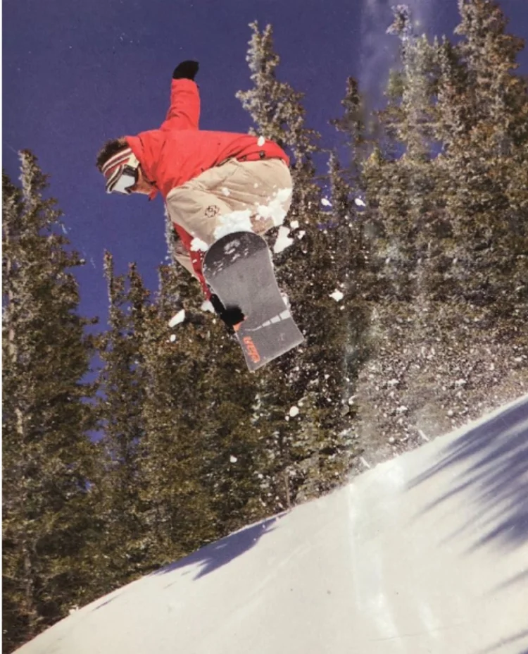 Jarrod mid-air on a snowboard