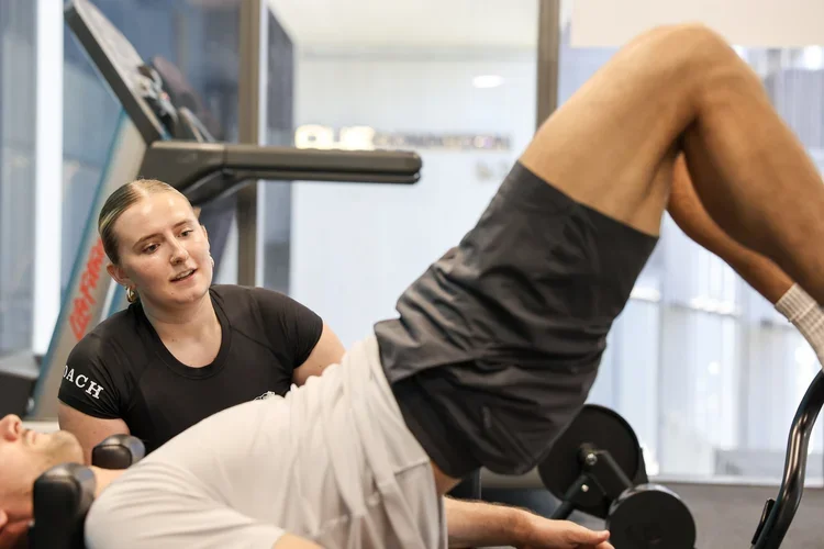 Coach Poppy leading a private 1-1 Pilates session at Strength Clinic Academy OUE Downtown Singapore