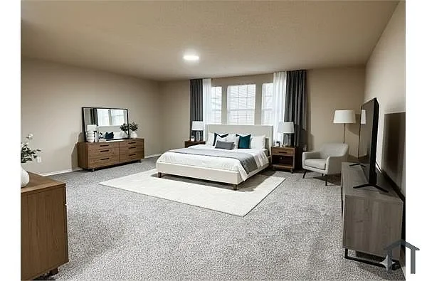 Spacious bedroom with a large bed, two bedside tables with lamps, a dresser with a mirror, a TV on a stand, and an armchair near a window with curtains.