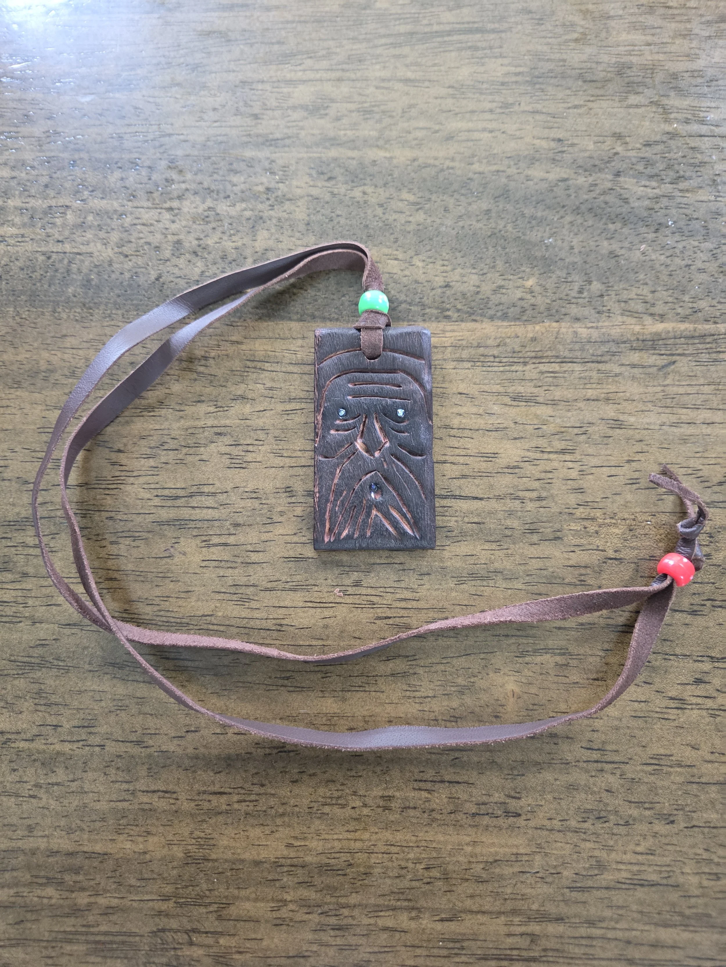 Blue-Eyed Wood Spirit – Hand-Carved Eucalyptus Pendant