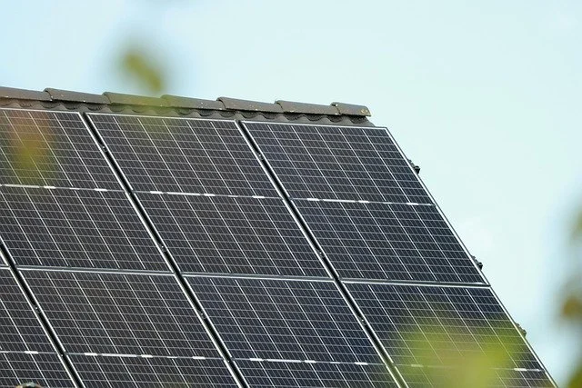 Close-up of solar panels installed on a roof, capturing sunlight for renewable energy.
