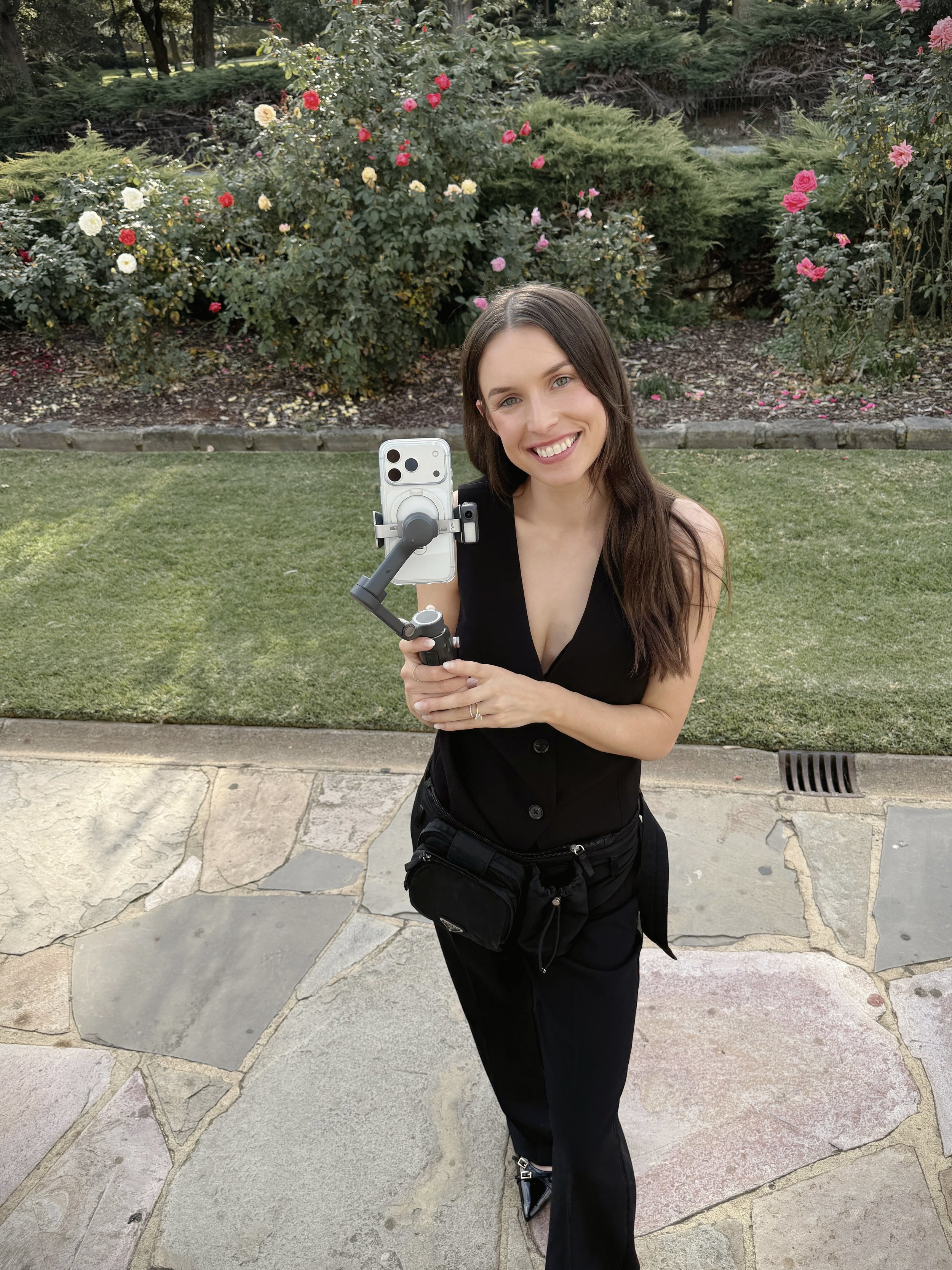 Wedding content creator filming behind-the-scenes moments on iPhone during a wedding day, capturing candid interactions and in-between moments in a relaxed, unobtrusive way in Bendigo.
