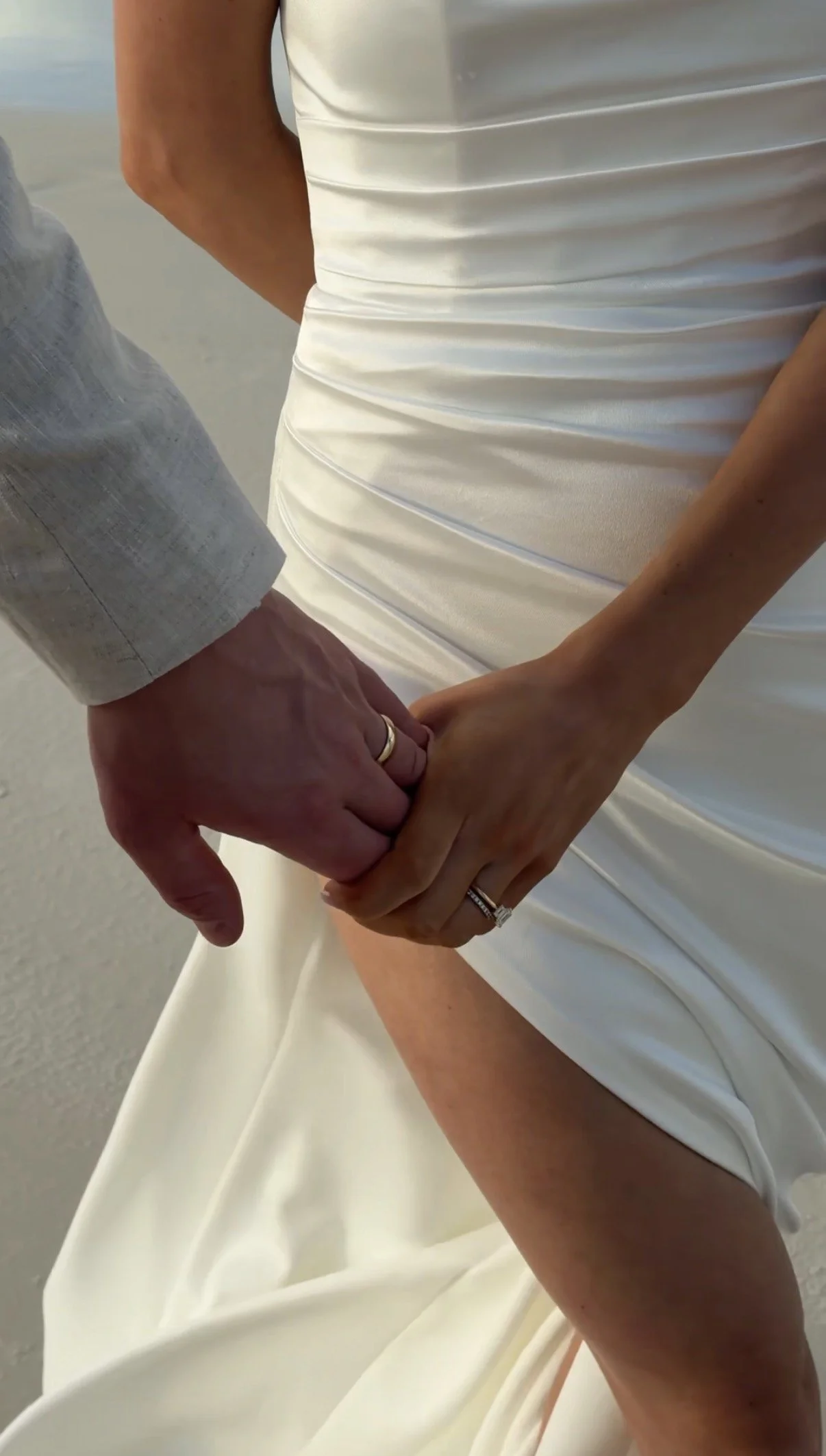 Close, candid moment of a bride and groom holding hands during their wedding ceremony, captured in a natural, behind-the-scenes style by a wedding content creator in Bendigo, focusing on real emotion and connection.
