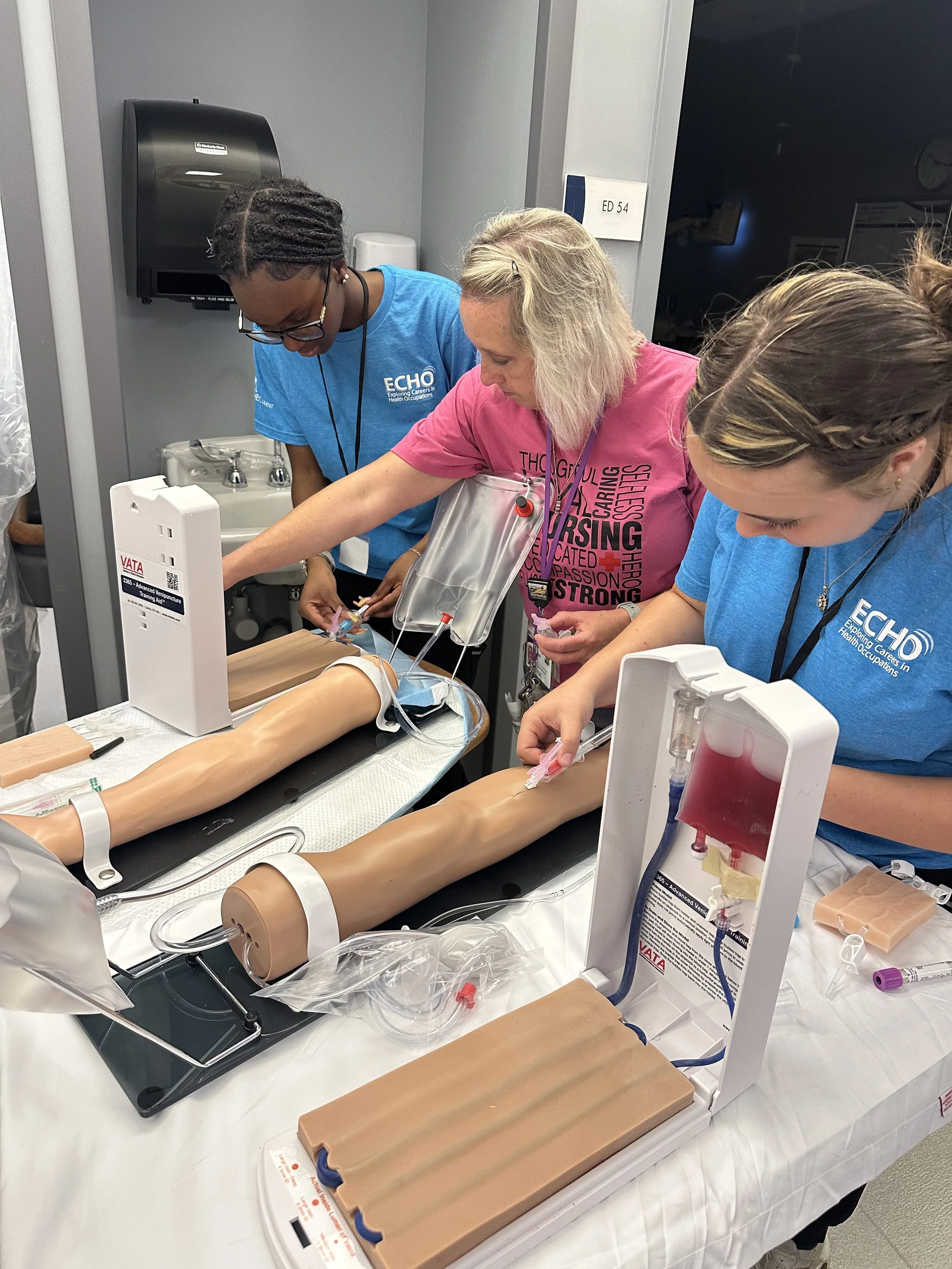 ECHO students practicing venipuncture skills