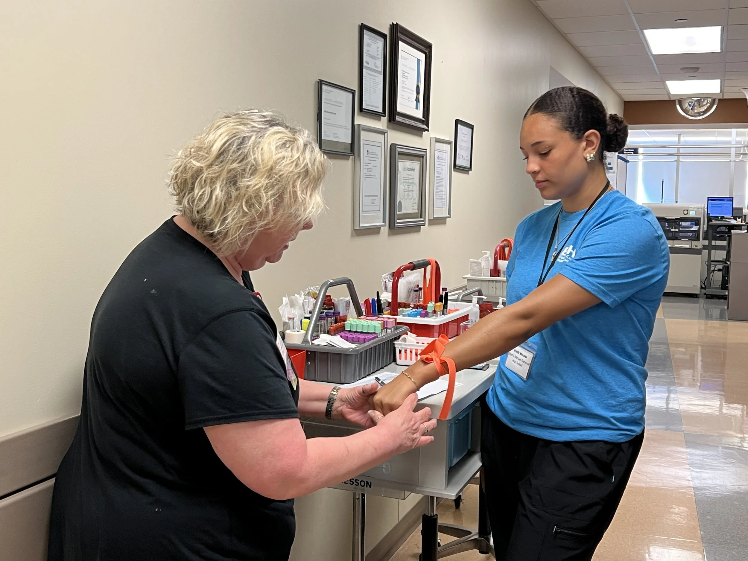 ECHO student practicing blood draw technique