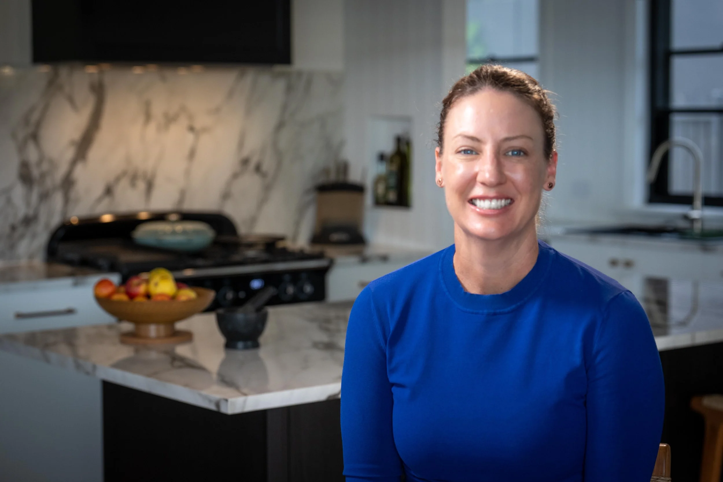 Smiling woman in a blue shirt who is our advanced sports dietitian