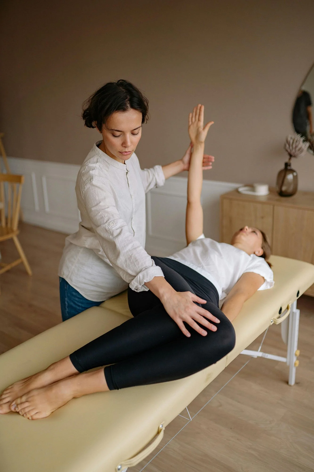 In-Home Physiotherapy consultations woman providing physio care for a female patient in their home