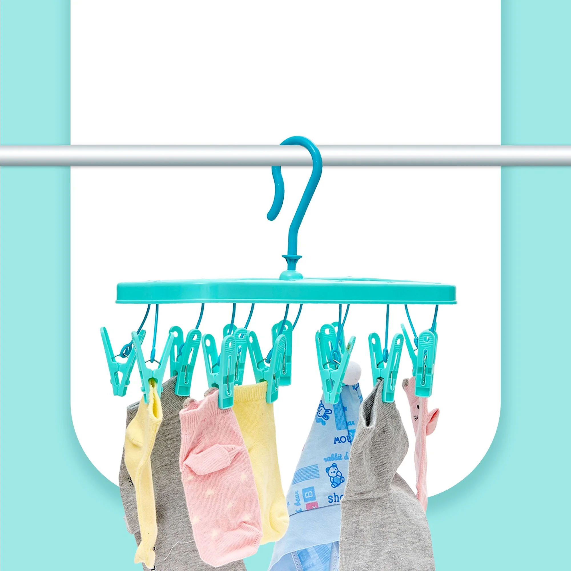 Multiple colorful baby socks hanging on a drying rack with clothespins.