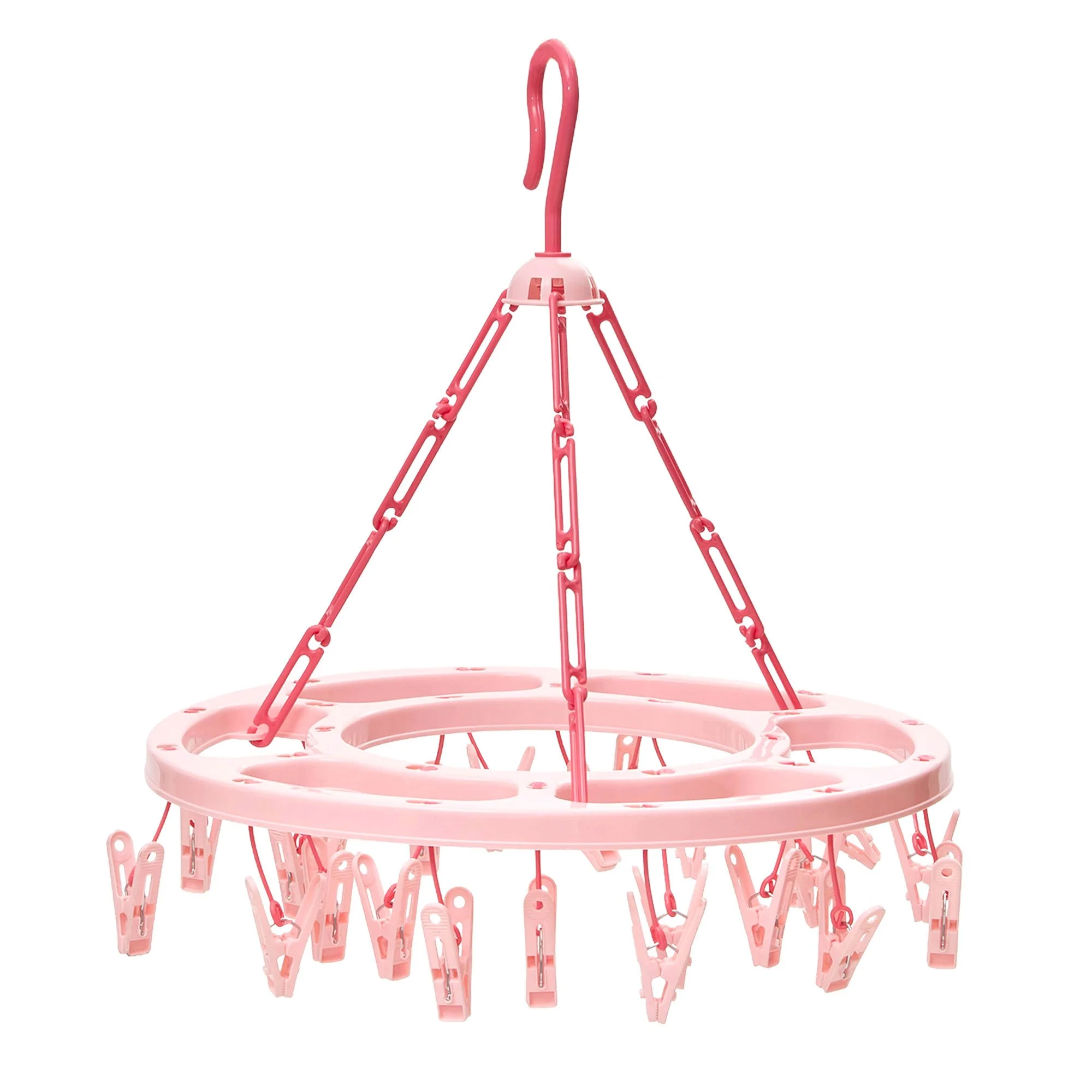 Pink plastic clothespins arranged in a circular pattern with a stand for hanging clothes.