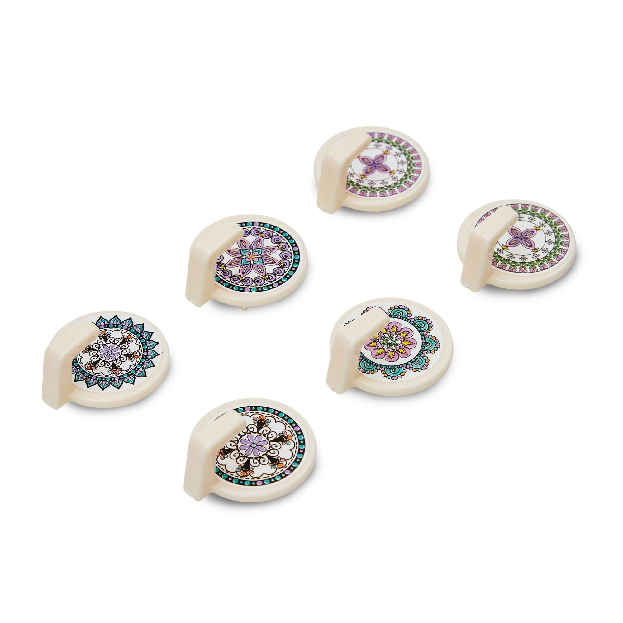 Decorative white game pieces with colorful mandala patterns on top, arranged on a white background.